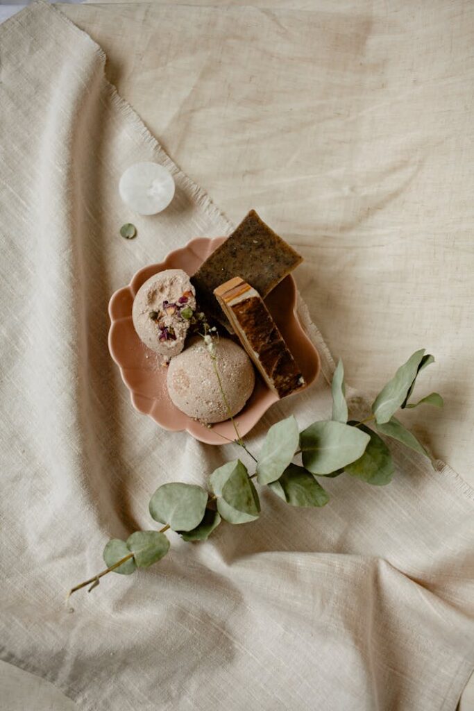 A Set of Bar Soaps on a Tray Beside Green Leaves
