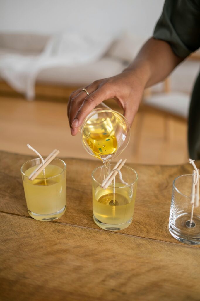 Person Holding a Glass with Yellow Liquid